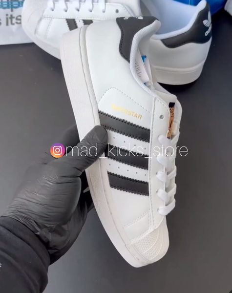 Black stripe white Adidas sneakers