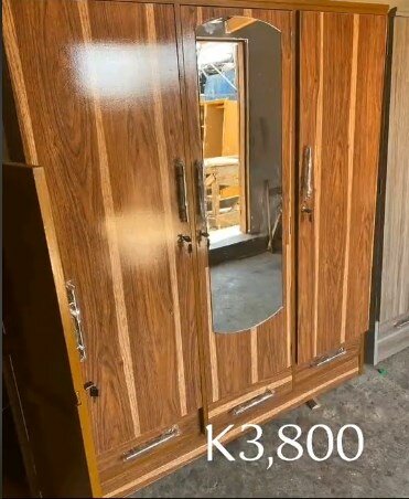 Brown wardrobe with drawers and mirror