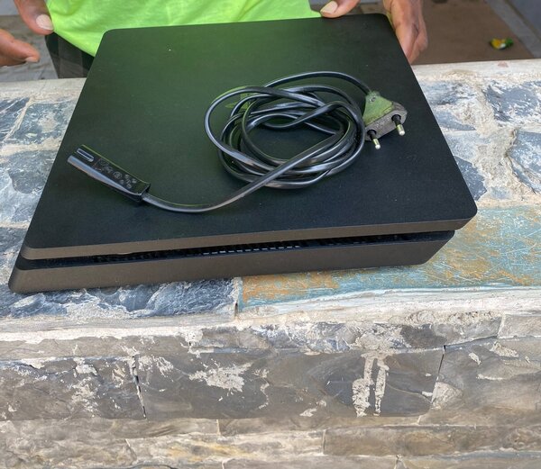 PS4 slim with one controller and FC 25 and 4 other games