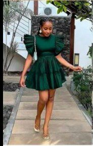 The dress is dark green, the sleeves and hem are multi-layered