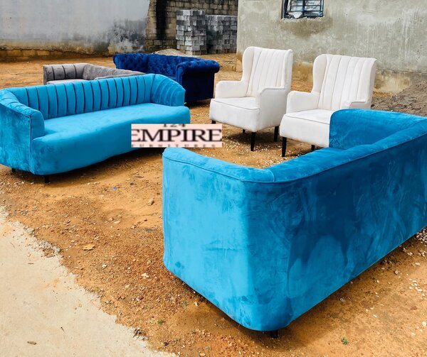 A set of furniture, blue sofas and white armchairs
