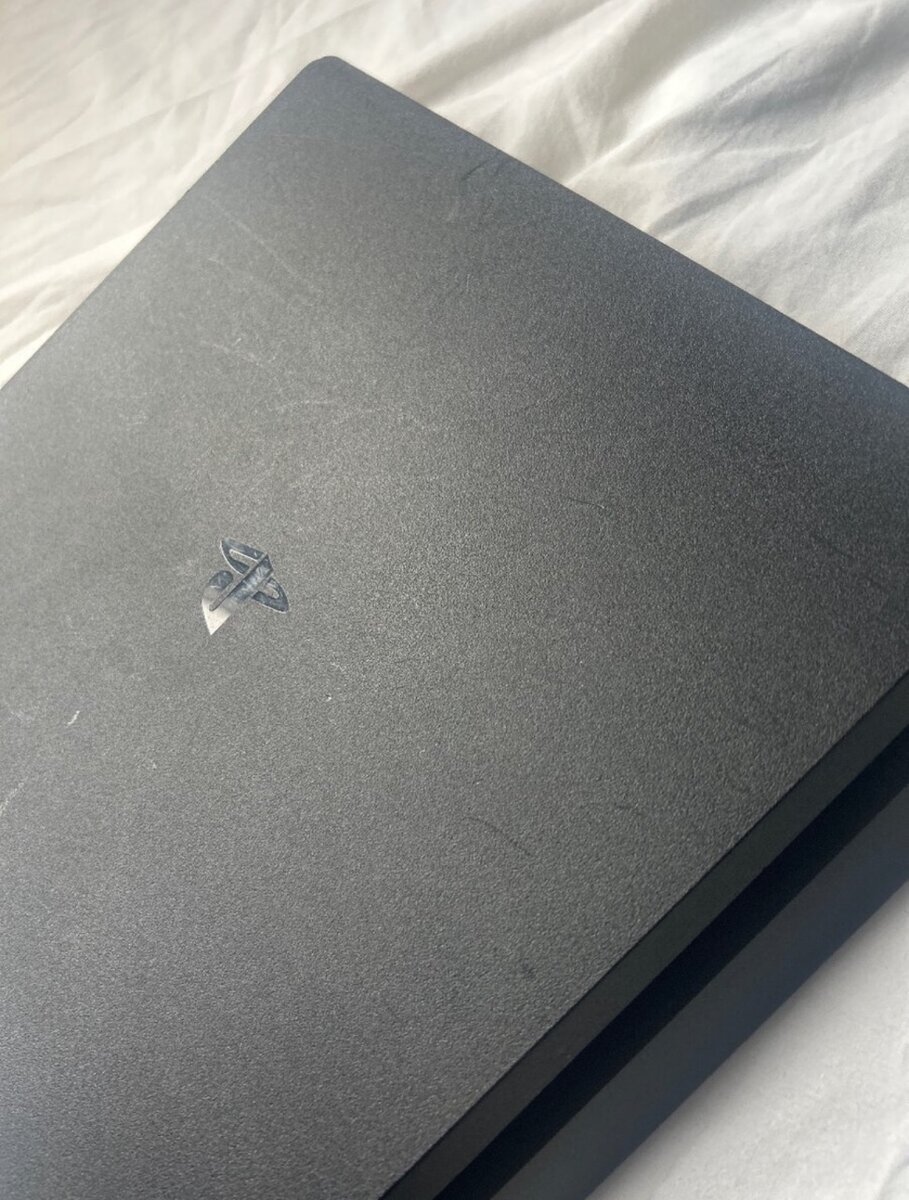 PlayStation 4 with controllers and games