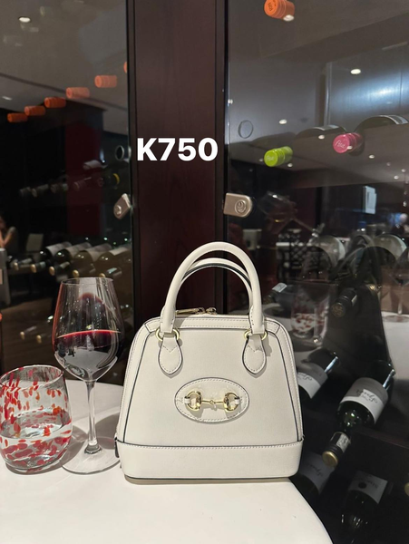 white bag with gold buckle