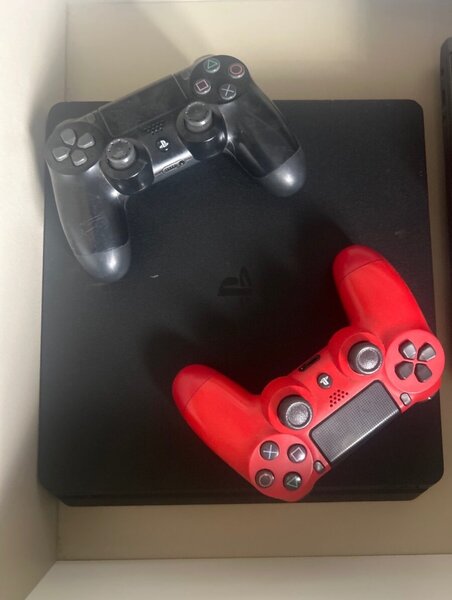 PlayStation 4 with controllers and games