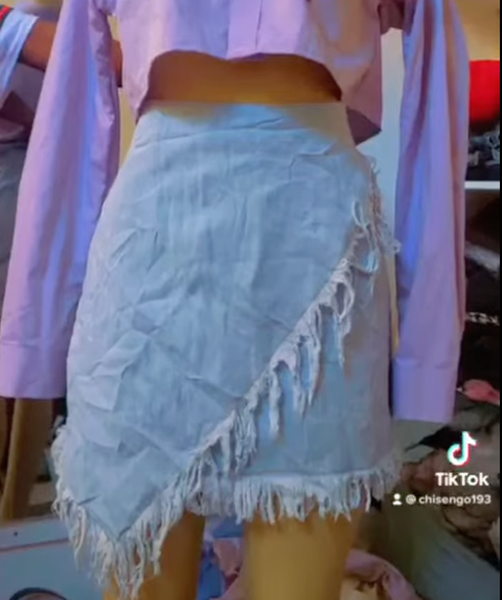 Asymetric denim fringed mini skirt 