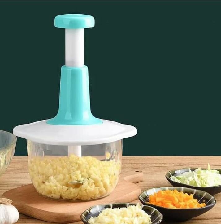 Hand pushing vegetable grater