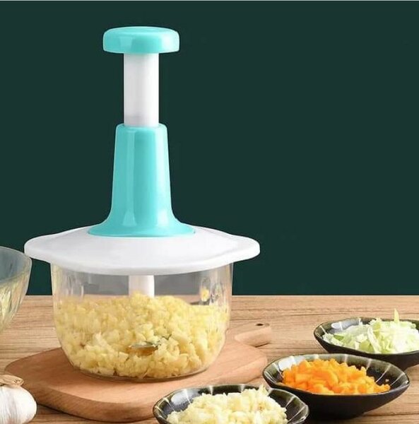 Hand pushing vegetable grater