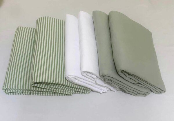 A set of bed linen in soft green and white shades with a striped pattern