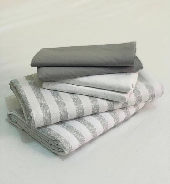 A set of bed linen in gray and white tones with a striped pattern