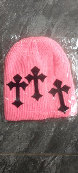 Bonnet en tricot rose avec croix noires