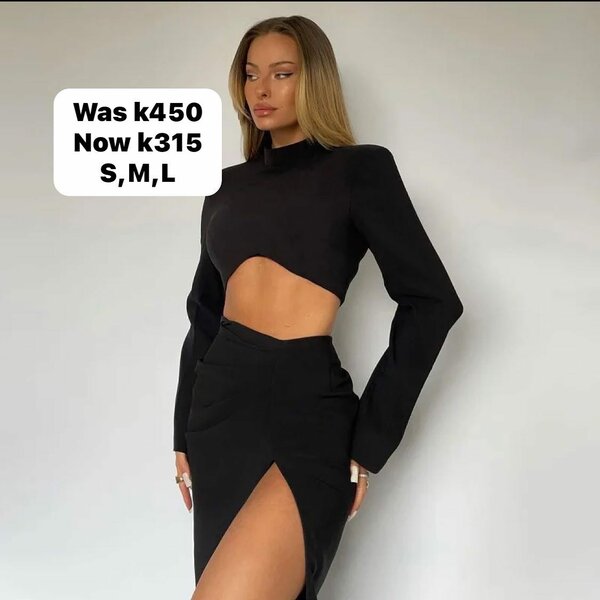 Women's suit is black, short top with long sleeves and a long tight skirt