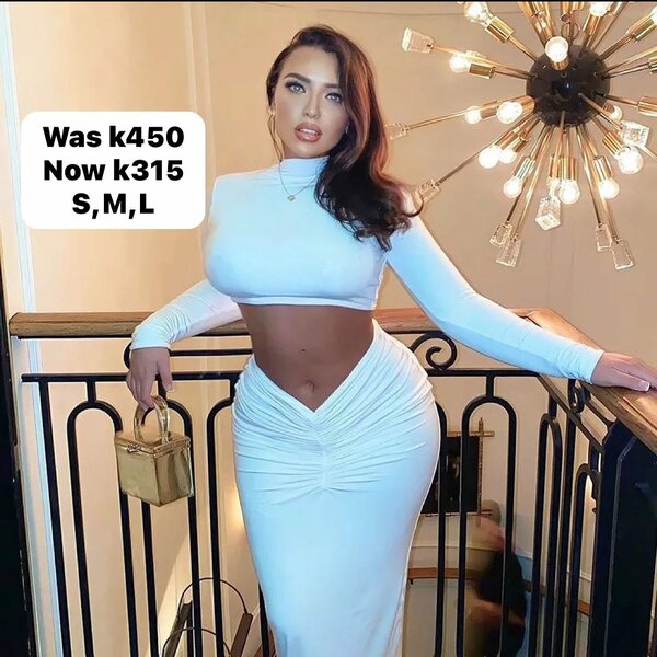 Women's suit is white, short top with long sleeves and a long tight skirt