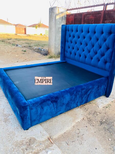 A bed with blue upholstery