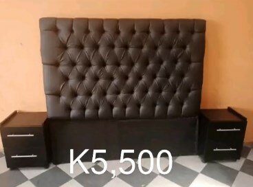 The headboard of the bed is soft, dark brown