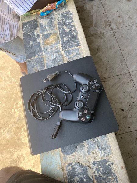 PS4 slim with one controller and FC 25 and 4 other games