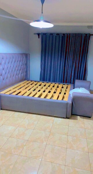 A bed with lilac upholstery