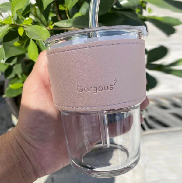 Glass tumblers with leather strap.