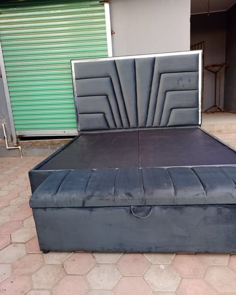 grey bed with carved headboard