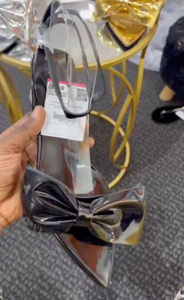 Patent leather black shoes with a bow