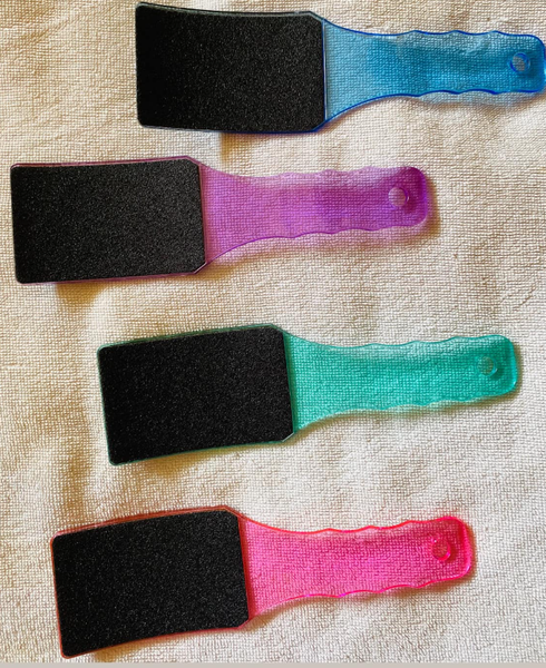 A pumice stone pedicure grater with a colored plastic handle, in stock