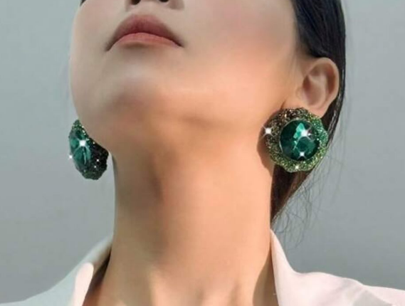 Beautiful fashionable earrings emerald