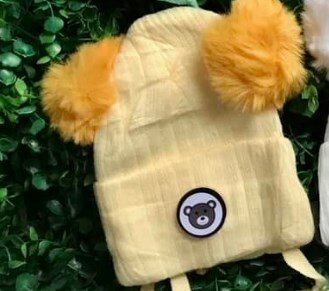 Beanie with 2 pompoms and ties, beige