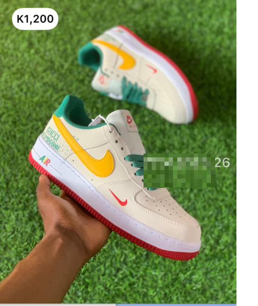 beige sneakers with yellow red and green