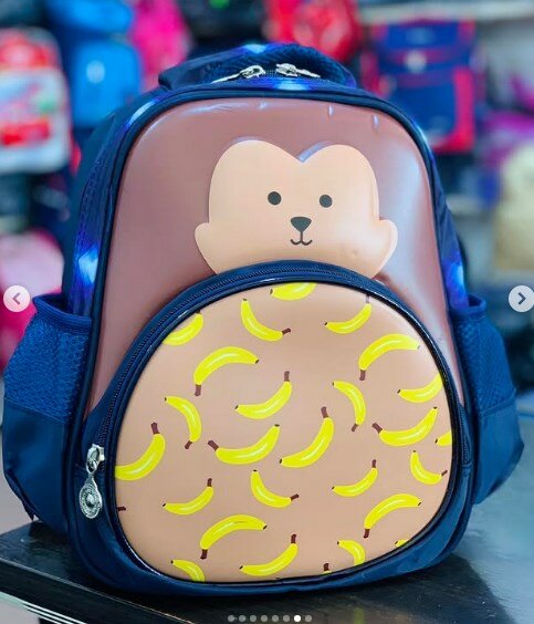 Blue and beige backpack with a monkey