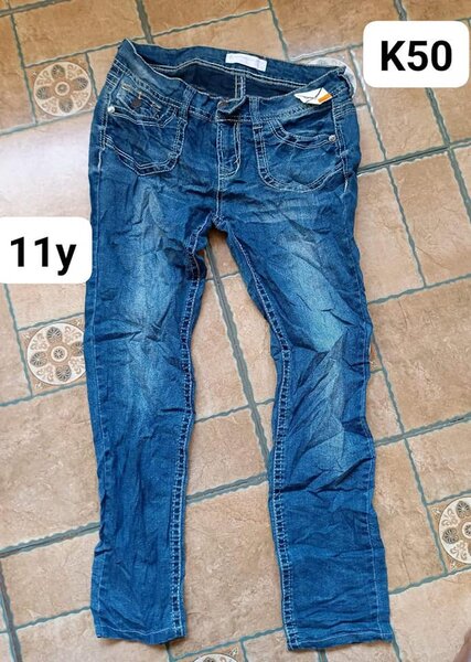 jeans are blue and unusual pockets
