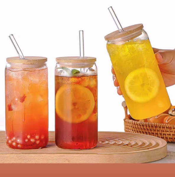 Glass jars with bamboo lid and glass tube for drinks